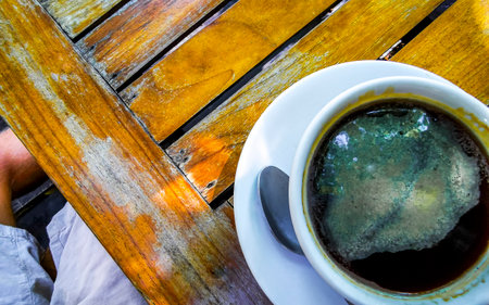 Glass pot cup of americano black coffee with spoon and plate on a table food and drink in the restaurant cafe in Playa del Carmen Quintana Roo Mexico.の写真素材