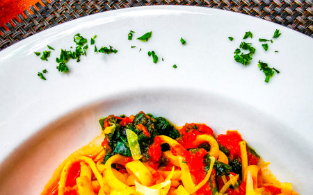 White plate of tasty pasta florentine noodles meal dish food and drink in the restaurant PapaCharly Papa Charly in Playa del Carmen Quintana Roo Mexico.の写真素材