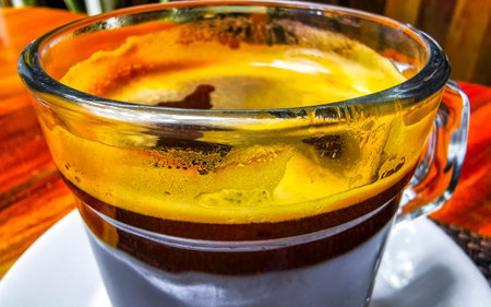 Glass pot cup of americano black coffee with spoon and plate on a table food and drink in the restaurant cafe in Playa del Carmen Quintana Roo Mexico.の写真素材