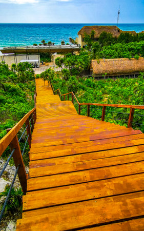 National park of Tulum panorama view to jungle beach sea coast and blue sky with wooden stairs in...