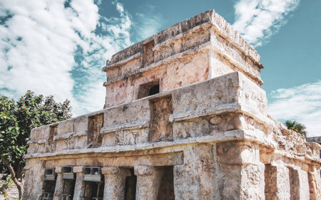 Ancient Tulum ruins Mayan site with the temple of the frescoes in the tropical natural jungle palm trees landscape panorama view in Tulum Mexico.の写真素材