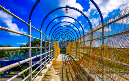 Playa del Carmen Quintana Roo Mexico November 6, 2024 Typical street road and cityscape with cars traffic pedestrian bridge overpass over highway of Playa del Carmen in Mexico.の写真素材
