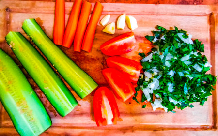Sliced salted cucumbers served on a wooden cutting board.の写真素材