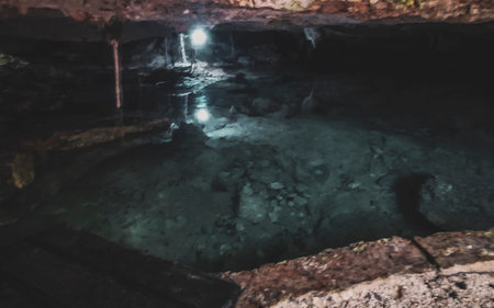 Beautiful Cenote Park Yaxmuul with limestone rocks turquoise blue green water and nature jungle around it in Tulum Quintana Roo Mexico.の写真素材
