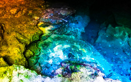 Beautiful Cenote Park Yaxmuul with limestone rocks turquoise blue green water and nature jungle around it in Tulum Quintana Roo Mexico.の写真素材