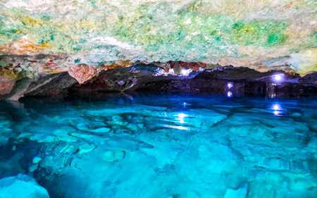 Beautiful Cenote Park Yaxmuul with limestone rocks turquoise blue green water and nature jungle...