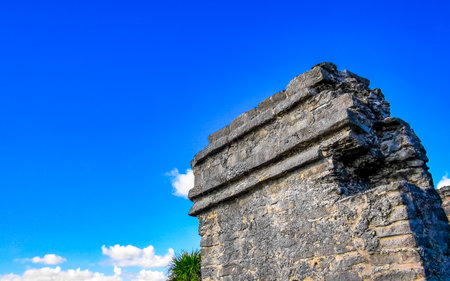 Ancient Tulum ruins Mayan site with temple ruins pyramids and artifacts in the tropical natural jungle palm trees landscape panorama view in Tulum Mexico.の写真素材
