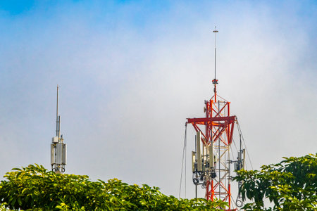 5G towers palm trees and blue sky in Playa del Carmen Quintana Roo Mexico.