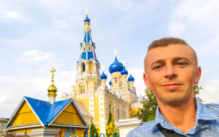 Tourist traveler at the famous Saint Nicholas church cathedral with blue onion dome in Leninskiy...