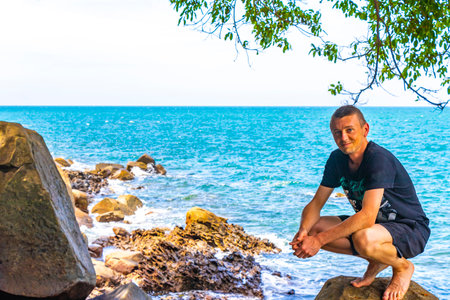 Male young tourist and traveler at beautiful amazing little small sandy beach landscape panorama view of the Khao Lak Lam Ru National Park Khuekkhak Amphoe Takua Pa Phang Nga Thailand.の写真素材