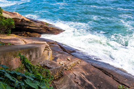 Urca Red Beach Tropical Paradise with Blue Turquoise Water Waves Palm Trees Rocks Hills Cliffs...