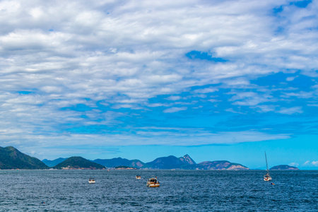 Urca Red Beach Tropical Paradise with Blue Turquoise Water Waves Palm Trees Rocks Hills Cliffs Seascape and White Beach Sand in Rio de Janeiro Brazil.の写真素材