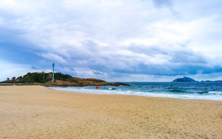 Rio de Janeiro Brazil October 10, 2010 Ipanema Beach Tropical Paradise with Two Brothers Hill Blue Turquoise Water and Dark Storm Rain Clouds.の写真素材