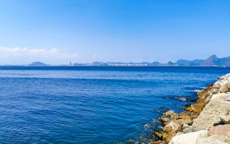 Beautiful Landscape Panorama Coastline Water Waves Rocks Mountains and Hills of Niteroi from Flamengo Beach in Rio de Janeiro Brazil.の写真素材