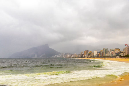 Rio de Janeiro State of Rio de Janeiro Brazil 10. October 2010 Ipanema Beach Tropical Paradise with Two Brothers Hill Blue Turquoise Water and Dark Storm Rain Clouds in Brazil.の写真素材