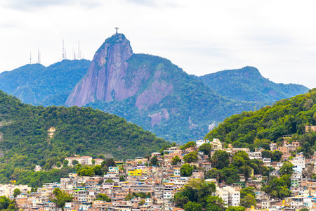 Christ the Redeemer Cristo Redentor on Corcovado mountain hill rock and cityscape city and tropical rainforest blue cloudy sky panorama view of Alto da Boa Vista Brazil.の写真素材