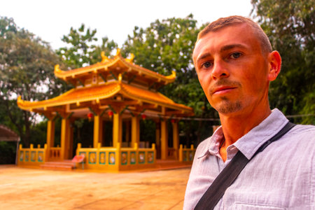 Man Tourist and Traveler at the Wat Wang Sam Sien Temple Shrine Chinese Pavilion in Pattaya Bang Lamung Chon Buri Thailand.の写真素材