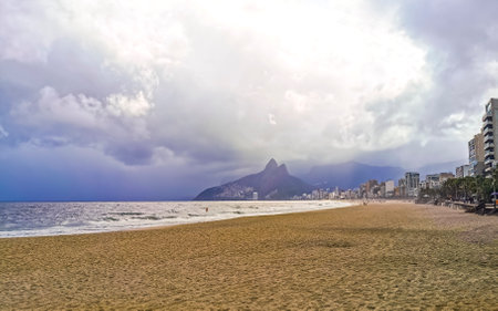 Rio de Janeiro State of Rio de Janeiro Brazil 10. October 2010 Ipanema Beach Tropical Paradise with Two Brothers Hill Blue Turquoise Water and Dark Storm Rain Clouds.の写真素材