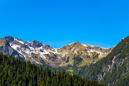 Mountain and alpine hill landscape mountains rocks and peaks panorama with snow nature and blue sky in the Alps Imst Tyrol Austria.の写真素材