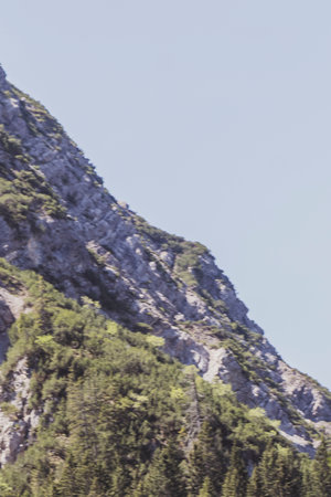 Mountain and alpine hill landscape mountains and rocks peaks panorama with green fields forest fir...