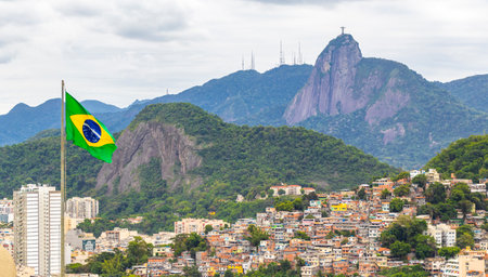 Christ the Redeemer Cristo Redentor statue and Brazilian Flag on Corcovado mountain hill rock and panorama view of Alto da Boa Vista Brazil.の写真素材