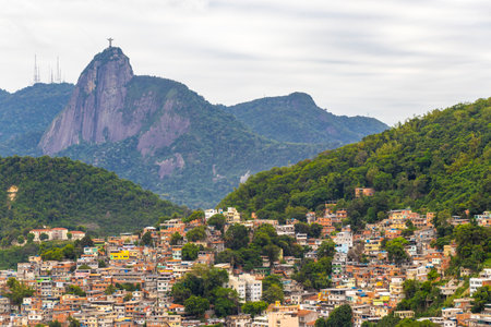 Christ the Redeemer Cristo Redentor on Corcovado mountain hill rock and cityscape city and tropical rainforest blue cloudy sky panorama view of Alto da Boa Vista Brazil.の写真素材