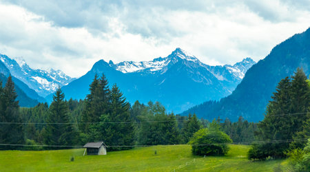 Mountain and alpine hill landscape mountains rocks and peaks panorama with snow nature and cloudy blue sky in the Alps Reutte Tyrol Austria.の写真素材