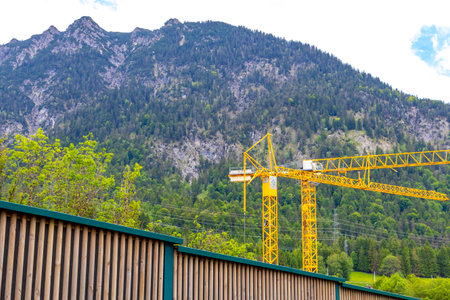 Reutte Tyrol Austria June 1st, 2025 Large yellow crane in the mountains in the Alps Reutte Tyrol Austria.の写真素材