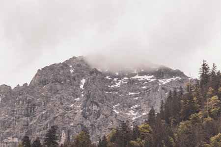 Mountain and alpine hill landscape mountains rocks and peaks panorama with snow nature and cloudy blue sky in the Alps Reutte Tyrol Austria.の写真素材