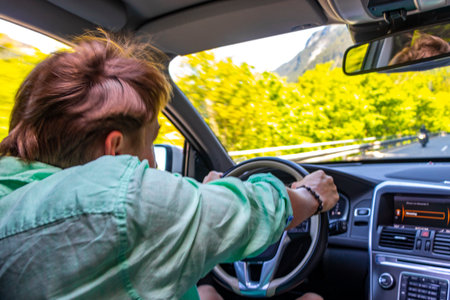 Man drives crazy through a bend in the mountains in the Alps Imst Tyrol Austria.の写真素材