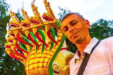 Man Handsome Tourist at the Wat Phra Yai Big Buddha Temple with stairs and dragon naga snake serpent guardian on Phra Tamnak Mountain Hill in Pattaya Thailand.の写真素材