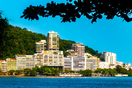 Barra da Tijuca Beach Tropical Paradise with Promenade Blue Hills Mountains Water Palm Trees and City Skyline in Rio de Janeiro State of Rio de Janeiro Brazil.の写真素材