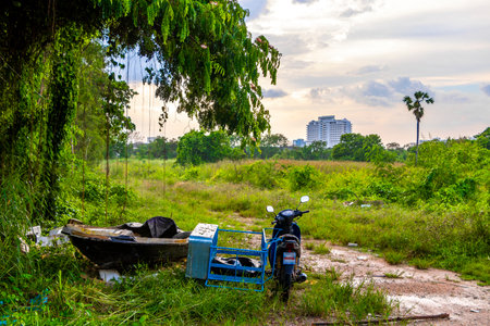 Motorbike boat vehicles left in the tropical nature jungle in Pattaya Bang Lamung Amphoe Chon Buri Thailand in Southeastasia Asia.の写真素材
