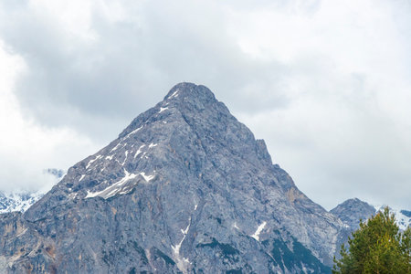 Panorama view of Germanys largest mountain Zugspitze alpine landscape with forest rocks hills snow peak clouds and mountains in the Alps Biberwier Reutte Tyrol Austria.の写真素材