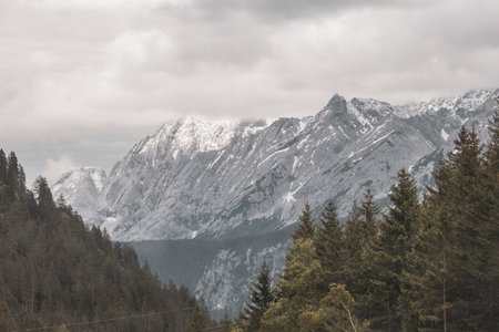 Panorama view of Germanys largest mountain Zugspitze alpine landscape with forest rocks hills snow peak clouds and mountains in the Alps Biberwier Reutte Tyrol Austria.の写真素材