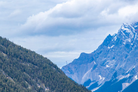 Panorama view of Germanys largest mountain Zugspitze alpine landscape with forest rocks hills snow peak clouds and mountains in the Alps Biberwier Reutte Tyrol Austria.の写真素材