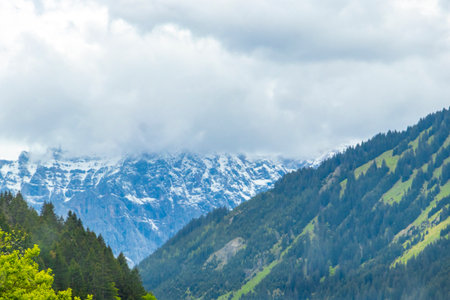 Panorama view of Germanys largest mountain Zugspitze alpine landscape with forest rocks hills snow peak clouds and mountains in the Alps Biberwier Reutte Tyrol Austria.の写真素材