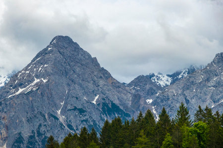 Panorama view of Germanys largest mountain Zugspitze alpine landscape with forest rocks hills snow peak clouds and mountains in the Alps Biberwier Reutte Tyrol Austria.の写真素材