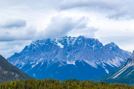 Panorama view of Germanys largest mountain Zugspitze alpine landscape with forest rocks hills snow peak clouds and mountains in the Alps Biberwier Reutte Tyrol Austria.の写真素材