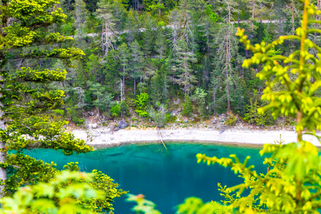 Turquoise blue green Blindsee lake river water forest rocks hills and mountains at Germanys largest...