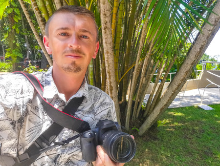 Photographer with camera at Green yellow bamboo and palm trees in tropical park on Corcovado Alto da Boa Vista Rio de Janeiro Brazil.の写真素材