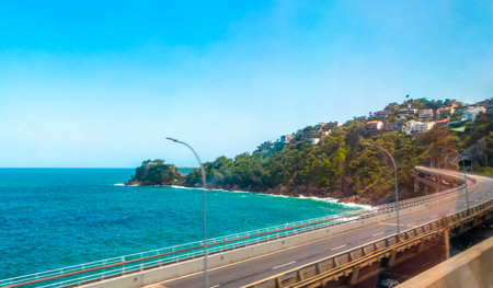 Barra da Tijuca Beach Tropical Paradise with Promenade Blue Hills Mountains Water Palm Trees and City Skyline in Rio de Janeiro State of Rio de Janeiro Brazil.の写真素材