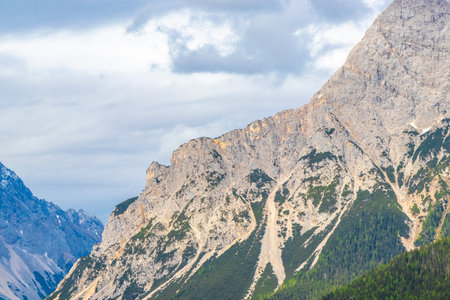 Panorama view of Germanys largest mountain Zugspitze alpine landscape with forest rocks hills snow...