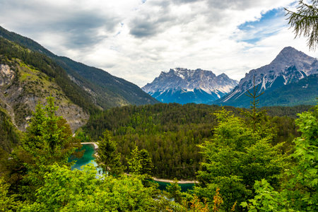 Panoramic view of Germanys largest mountain Zugspitze alpine landscape with turquoise Blindsee lake forest rocks hills and mountains in the Alps Biberwier Reutte Tyrol Austria.の写真素材