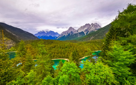 Panoramic view of Germanys largest mountain Zugspitze alpine landscape with turquoise Blindsee lake...