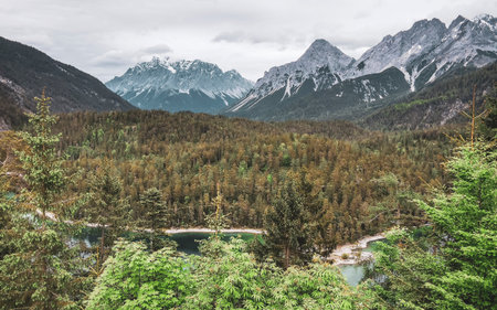 Panoramic view of Germanys largest mountain Zugspitze alpine landscape with turquoise Blindsee lake forest rocks hills and mountains in the Alps Biberwier Reutte Tyrol Austria.の写真素材