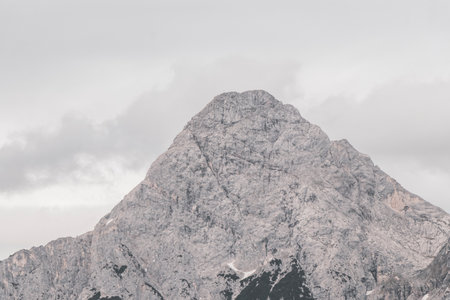Cold panoramic view of Germanys largest mountain Zugspitze peak alpine landscape with snow rocks hills clouds and mountains in the Alps Biberwier Reutte Tyrol Austria.の写真素材