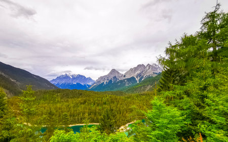 Panoramic view of Germanys largest mountain Zugspitze alpine landscape with turquoise Blindsee lake forest rocks hills and mountains in the Alps Biberwier Reutte Tyrol Austria.の写真素材