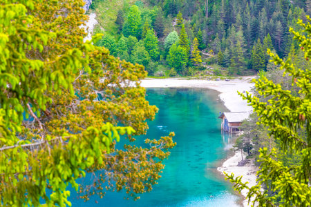 Turquoise blue green Blindsee lake river water forest rocks hills and mountains at Germanys largest mountain Zugspitze alpine landscape panorama in the Alps Biberwier Reutte Tyrol Austria.の写真素材