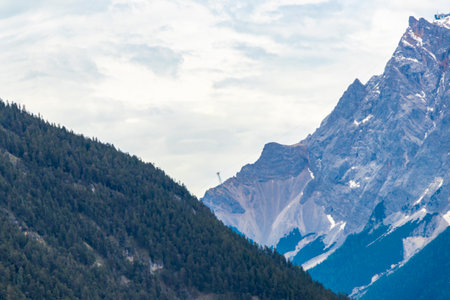 Cold panoramic view of Germanys largest mountain Zugspitze peak alpine landscape with snow rocks hills clouds and mountains in the Alps Biberwier Reutte Tyrol Austria.の写真素材